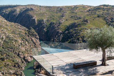 Wooden and glass structure of the Fraga do Puio viewpoint in Picote with the Douro River in the background in Miranda do Douro, Portugal clipart