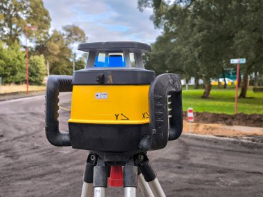 High-precision laser leveler, an essential tool for road engineering and renovation projects clipart