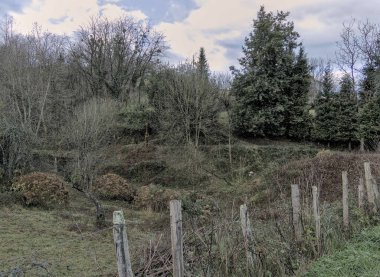 Etrafı dikenli tellerle çevrili bir arazi.