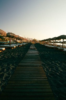 Seascape ve Chaise, Santorini 'deki Kamari' nin siyah plajlarını geziyor. Yüksek kalite fotoğraf