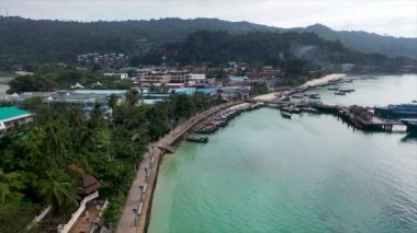 Aerial drone of Tonsai pier and iconic tropical beach and resorts of Phi Phi island, Thailand.