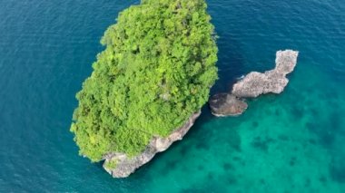 Drone Shot around paradise island with green limestone cliffs in Koh Phi Phi, Thailand.