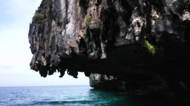 Closeup shot of a limestone rock in the middle of the ocean in Koh Phi Phi.