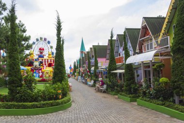 Bandungan - Indonesia, January 10, 2025 : View inside of New Celosia park with flower garden, kids game and lots of fairy tale style building decorations, located on Bandungan, Ungaran, Indonesia clipart