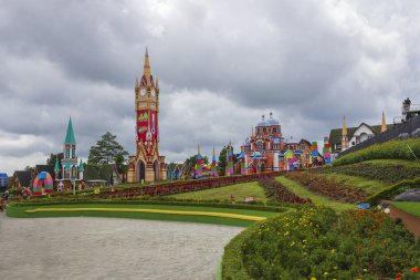 Bandungan - Indonesia, January 10, 2025 : View inside of New Celosia park with flower garden, kids game and lots of fairy tale style building decorations, located on Bandungan, Ungaran, Indonesia clipart