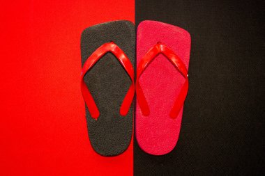 Black Red Flip Flops or called sandal jepit in different colors isolated on black and red background, top view clipart