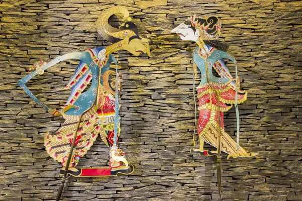 Wayang kulit veya Gölge kuklaları tipik Java, Endonezya, tuğla duvarda asılı sıcak ışıkla 