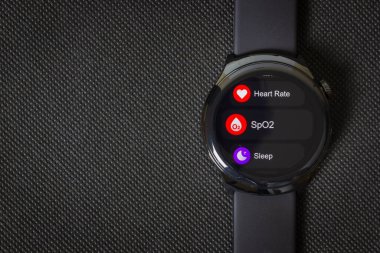 Surakarta - Indonesia, January 6, 2025 : A Mibro lite 3 pro smartwatch with features interface isolated on black background, copy space clipart