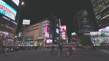 Shibuya, Tokyo 'daki kavşağı geçen bir çok insanla karşı karşıya.