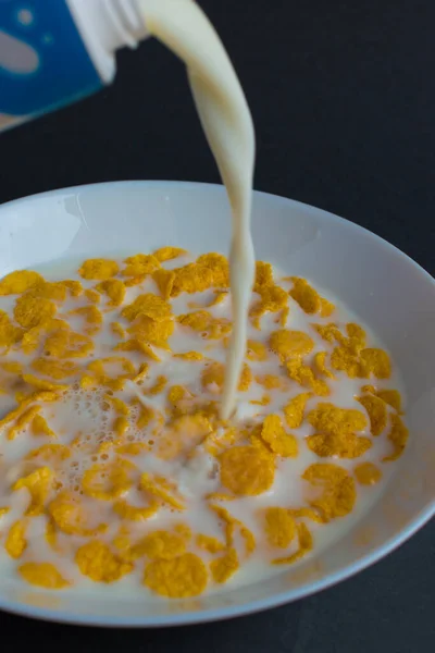 Cornflakes White Bowl Breakfast Cereal Splash Milk Isolated Dark Background — Stock Photo, Image