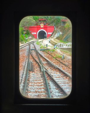 12 Nisan 2025 Lamphun, Tayland. Kuhn Tan Tren İstasyonu 'nun penceresinden bak. Güzel atmosfer. Demiryolu tüneli ziyaret etmek için heyecan verici bir yerdir..