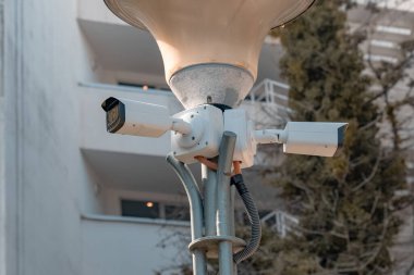 İki yan yana asılan CCTV kameraları, bina sakinlerinin güvenliği için binanın köşesine yerleştirildi..