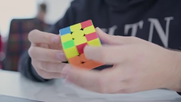 Черногория Бар 2023 Мужчина Собирает Кубик Рубика Сидящего Белым Столом — стоковое видео