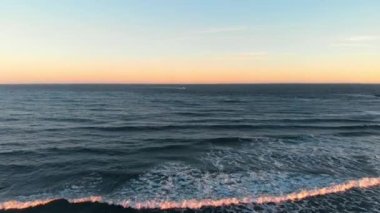 drone video of waves breaking on the beach