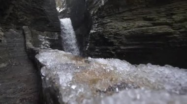 hail falling in slow motion near a waterfall at watkins glen state park in new york