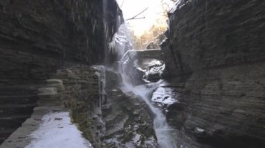 a cascade of waterfalls inside a cavern. rainbow falls at watkins glen state park in new york