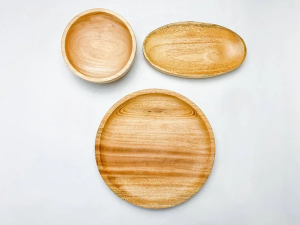 stock image Flat lay of the empty wooden plate and wooden bowl on white background.
