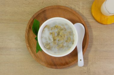 Mung Bean Porridge or Bubur Kacang Hijau, Indonesian dessert porridge of mung beans with coconut milk, pandan leaf and ginger. Served in bowl. clipart