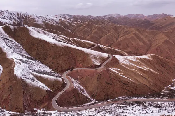Tibet platosunda, karla kaplı tepeler ve engebeli tepeler arasında bir yılan yolu var. Bu kış manzarası bu uzak bölgenin sert güzelliğini ve soğuk iklimini sergiliyor..