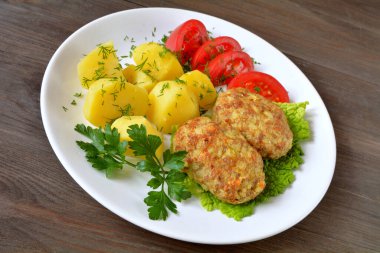 Pirinç ve lahana dilimlenmiş pirzola, patates ve domates.