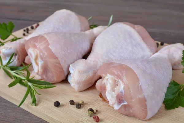 stock image raw chicken legs on a wooden board