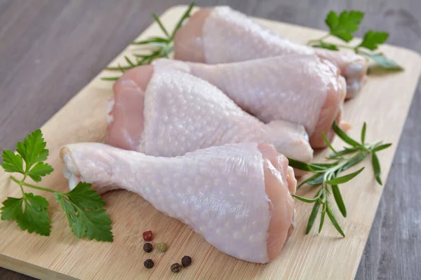 stock image raw chicken legs on a wooden board