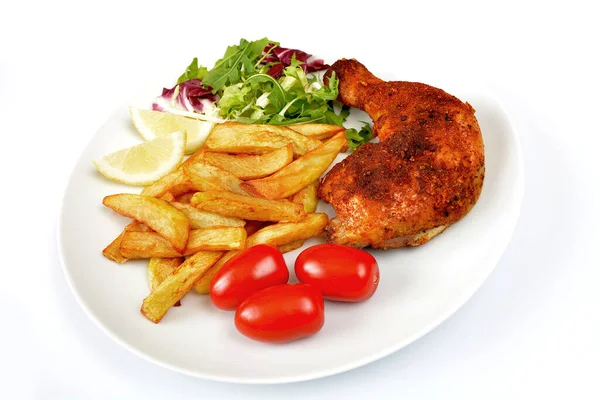 baked chicken leg with fries, salad and tomato