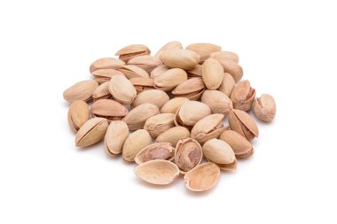 Beyaz zemin üzerinde kavrulmuş tuzlu şam fıstığı.