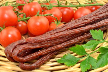 sausages and tomatoes on wicker