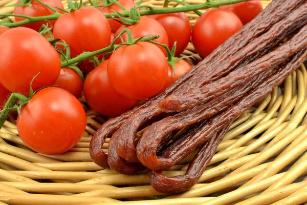 sausages and tomatoes on wicker
