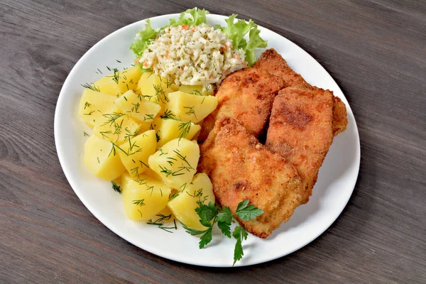 fried fish with potatoes and salad