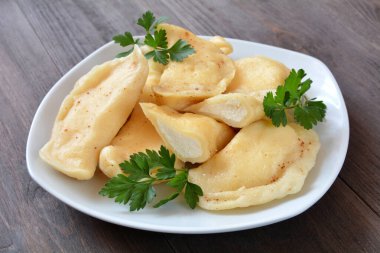 dumplings with cheese on a plate