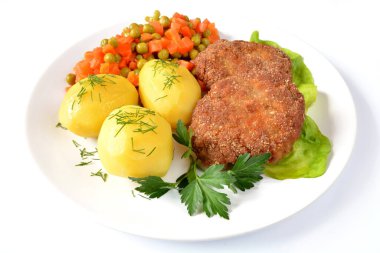 minced cutlets with potatoes, carrots and peas
