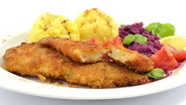 pollock fried with potatoes and vegetables