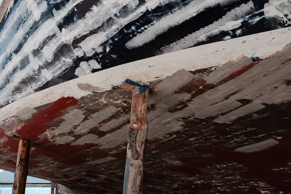 stock image wooden boat hull in dry dock maitenance ready for paint, maintenance of yacht