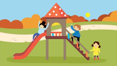 Çocuklar sonbaharda parkta kayağa binerler.