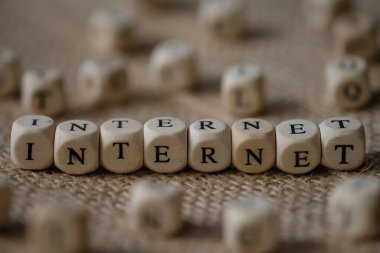 Internet word concept on wooden cubes blocks on burlap background