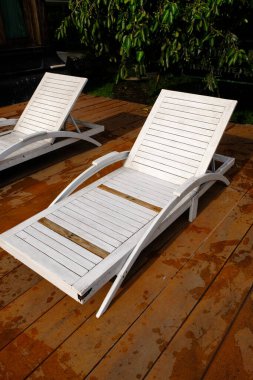 white sunbeds near the pool 