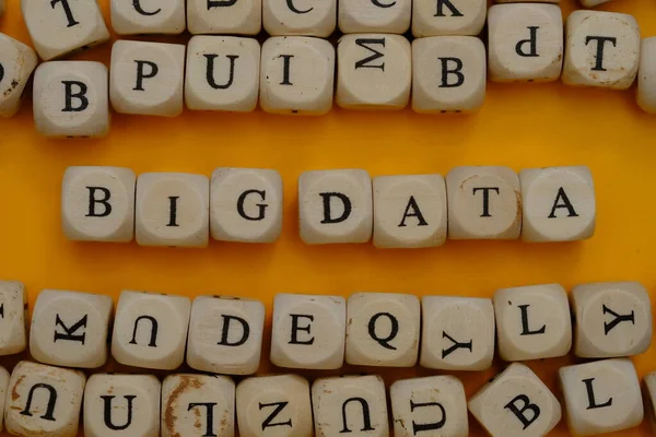 big data word concept on wooden cubes blocks on yellow background 