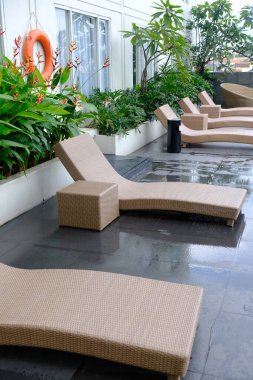 beautiful luxury hotel patio with sunbeds by the pool