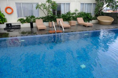 beautiful luxury hotel patio with sunbeds by the pool