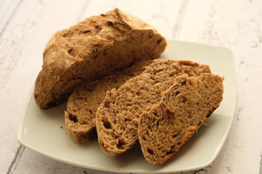 sliced brown bread made from whole wheat on a white ceramic plate 