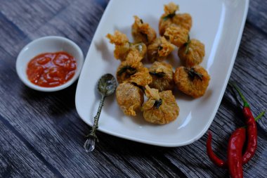 fried pastry with sauce on white plate