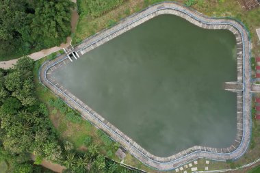 Yogya, Indonesia - March 2, 2021:Embung Imogiri is an artificial reservoir in the shape of a Gunungan Wayang. Flood control and irrigation facilities. Waduk buatan.
