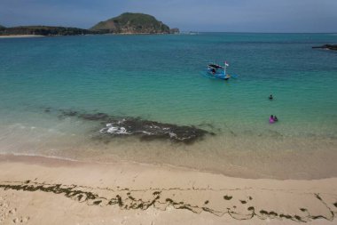 Aerial view of Tanjung Aan beach in Lombok Island, West Nusa Tenggara, Indonesia. Turquoise crystal clear water beach in tropical island.