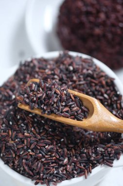 raw black rice in a white ceramic bowl