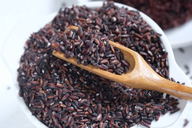 raw black rice in a white ceramic bowl