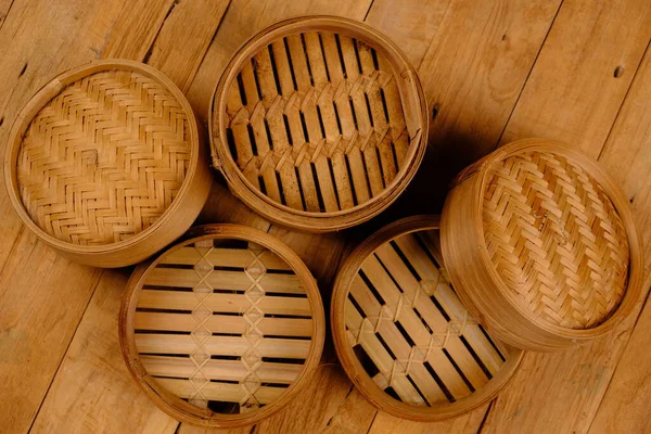 cooking utensils made of bamboo on a wooden planks background