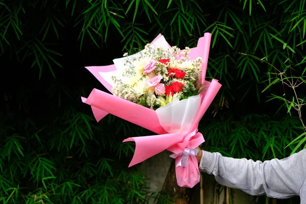 wedding bouquet of flowers and ribbon in hand