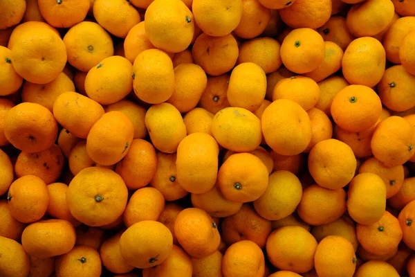 The mandarin orange, also known as mandarins or mandarines, is a small citrus tree fruit. Citrus reticulata. pile of oranges in the fruit shop. jeruk Medan.